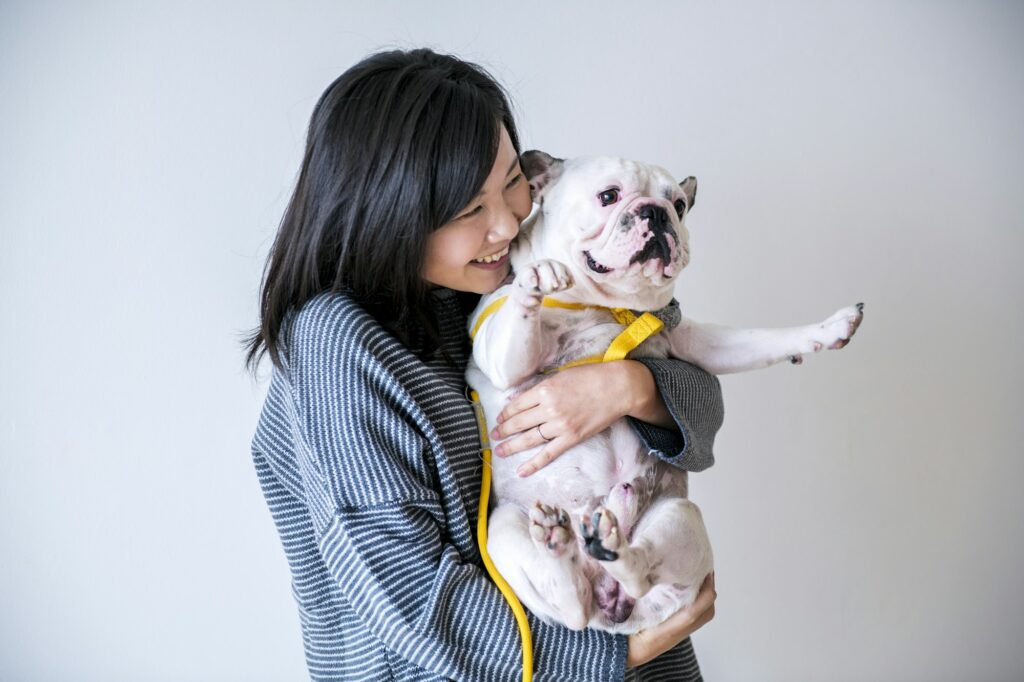 Asian woman hugging dog